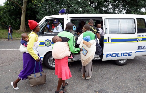 13.-Foreign-nationals-are-escorted-by-members-of-the-South-African-Police-Service-SAPS-after-a-xenophobic-attack-in-Durban-on-April-8-2015.-Photo-RAJESH-JANTILAL-AFP Municipality investigating allegations of theft at xenophobia camp